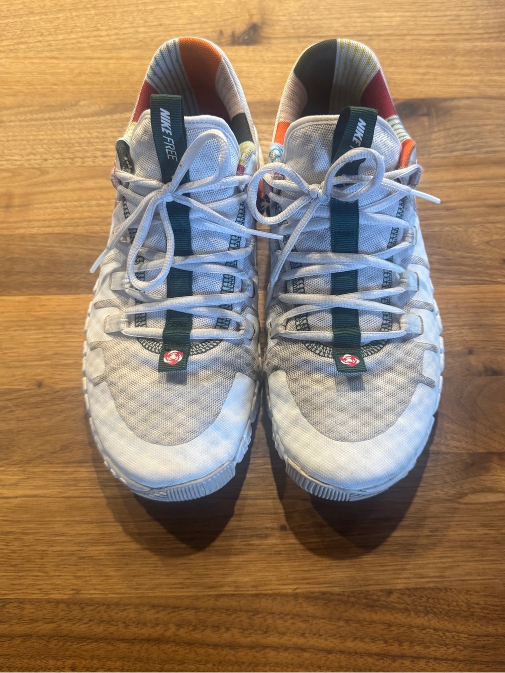 Nike women’s Metcons White Sneakers with Dark Green and Orange Accents